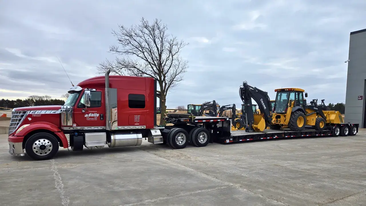 Daily Express driver moves backhoe open deck loads